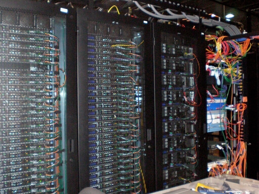 Rack servers in a Data center. "Data Center" — Just some servers in a data center. Sean Ellis, licensed under CC BY 2.0.