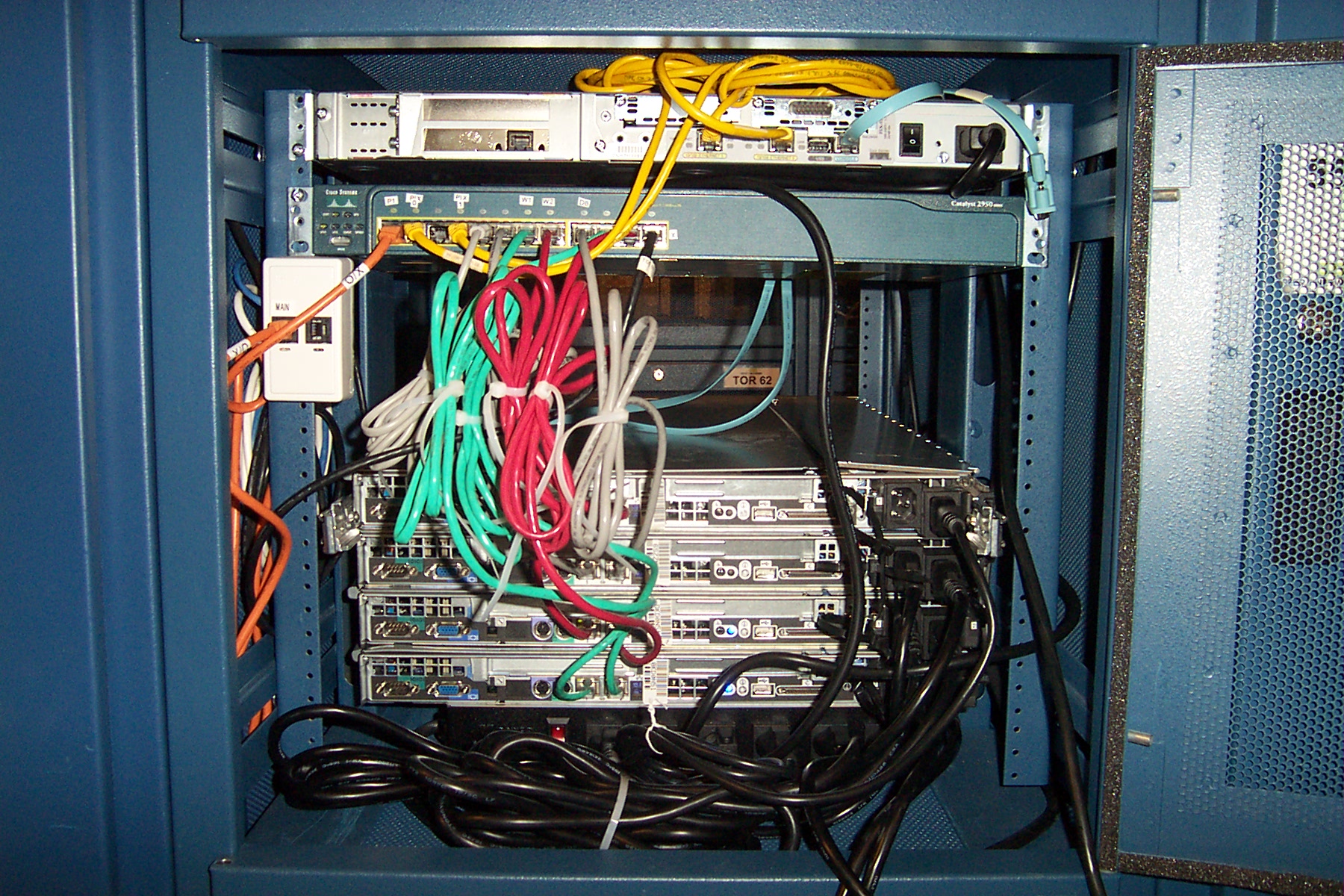 In this image, each "rack" is a server. "FSN data center backview" by Steve Hulford is licensed under CC BY-NC-ND 2.0.